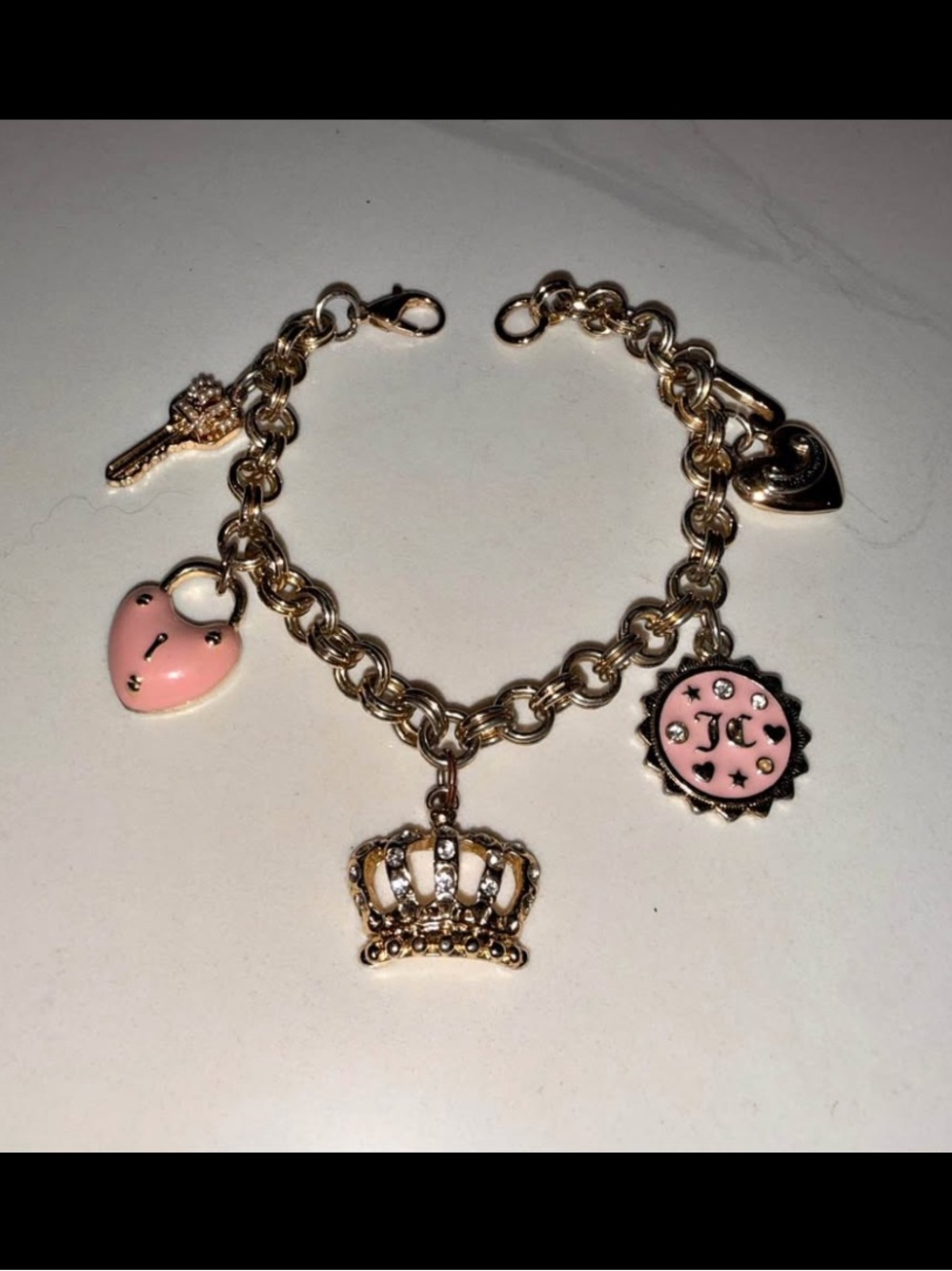 Juicy Couture Gold Charm Bracelet with Pink Enamel Heart, Crown & Medallion